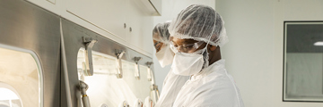 People wearing protective clothing working in a laboratory