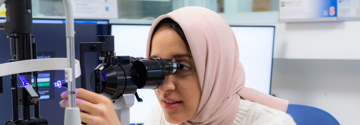 Staff member using a slit lamp